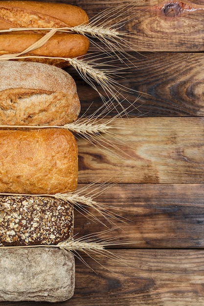 Fresh loaves of bread on wood