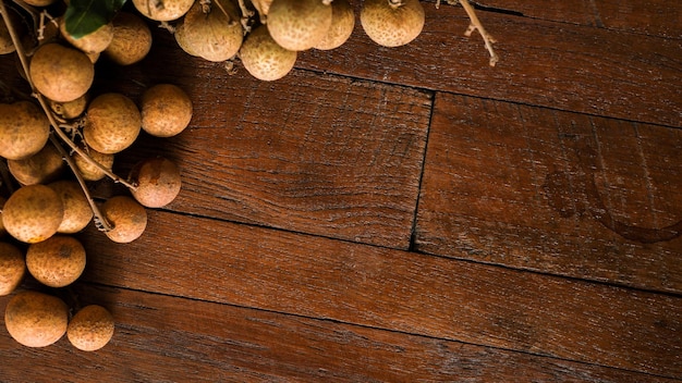 fresh longans in plate on wooden background