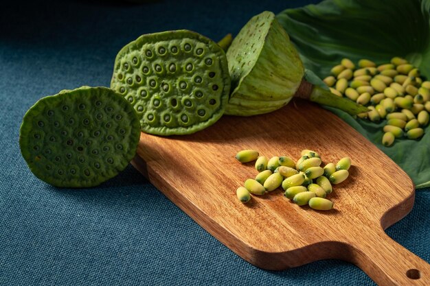 Fresh lotus seeds on a simple background