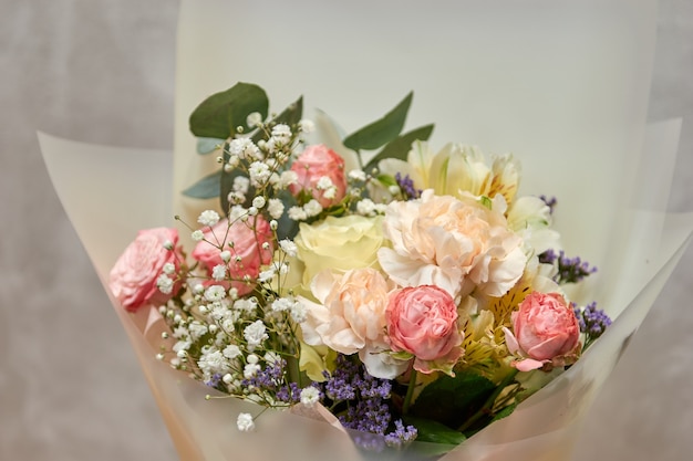 Fresh, lush bouquet of colorful mixed flowers. European floral shop concept. Flowers delivery. Beautiful fresh blossoming flowers in the florist shop fridge