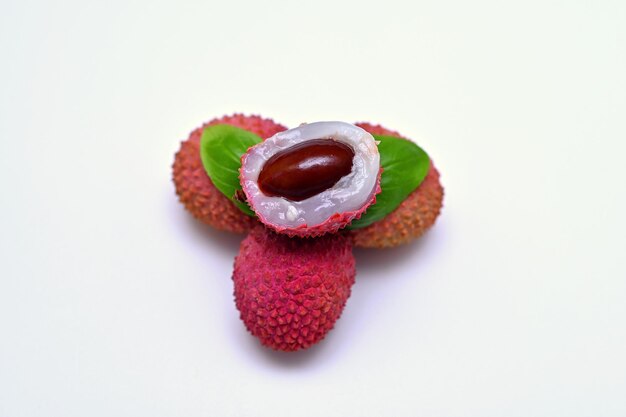 fresh lychee and half a fruit on a white background closeup