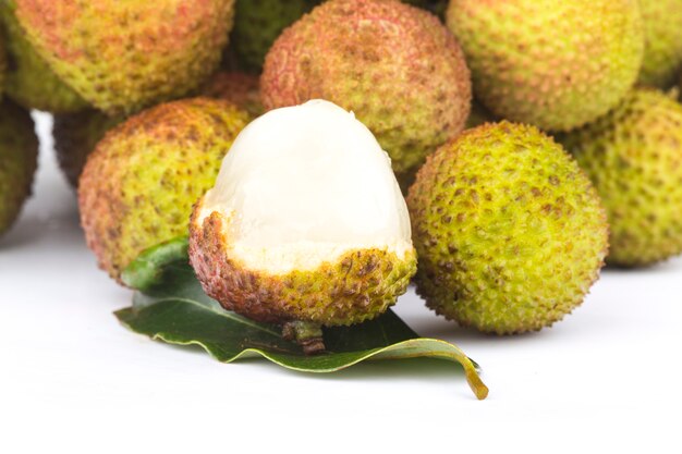 Fresh lychee with leaves isolated on white