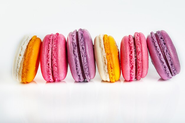 Fresh macarons of different colors and flavors isolated on white