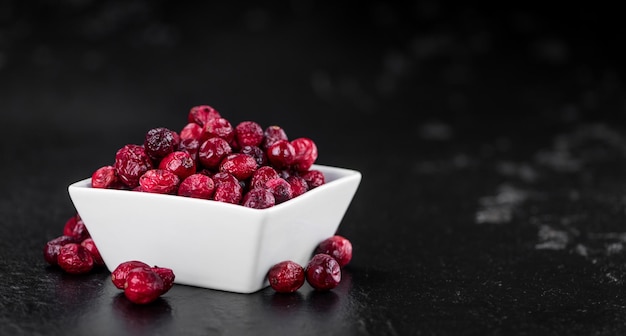 Fresh made Dried Cranberries on a slate slab closeup shot selective focus