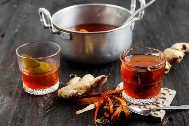 Fresh Made Indonesian Traditional Drink Wedang Uwuh Made From Ginger Secang Cloves Cardamom Dried Cinnamon On Wooden Table