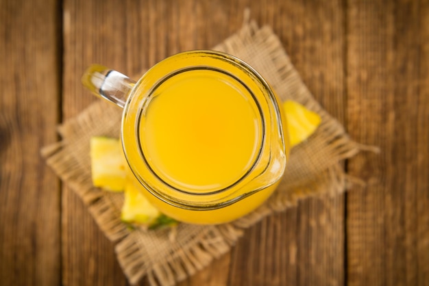 Fresh made Pineapple Juice on a rustic background