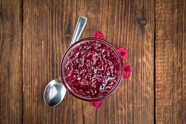 Fresh made Raspberry Jam on a rustic background