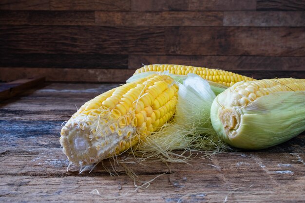 Fresh maize and corn on wooden floor