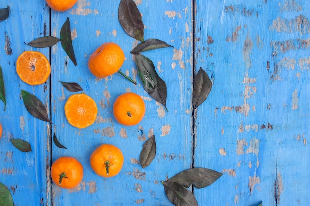 Fresh mandarin oranges fruit or tangerines with leaves on wooden table