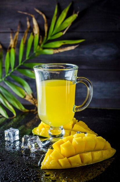 Fresh mango and mango juice in a glass