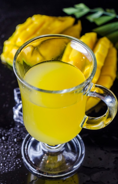 Fresh mango and mango juice in a glass