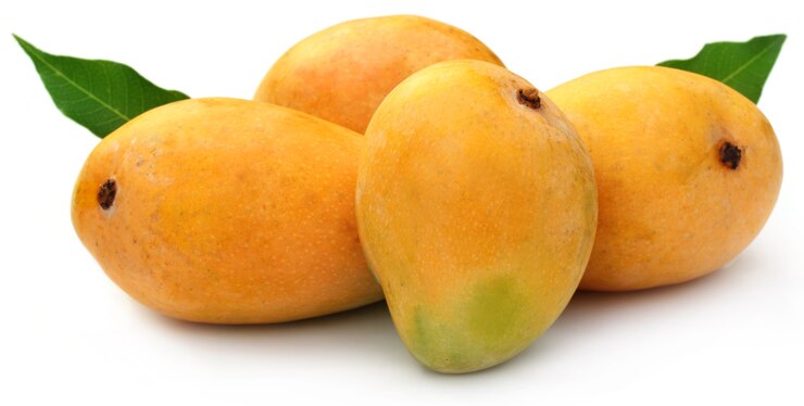 Photo fresh mangoes with green leaves over white background