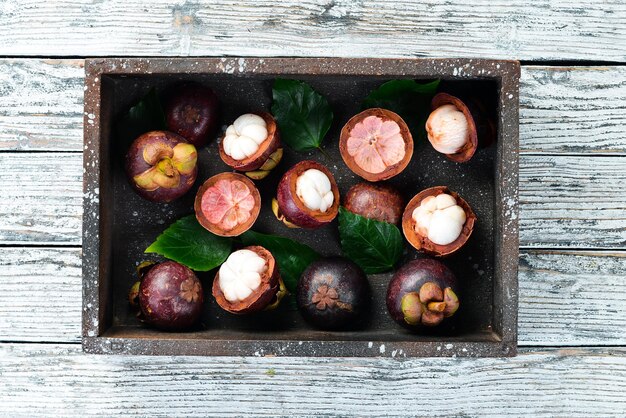 Fresh Mangosteen in a wooden box. Tropical Fruits.