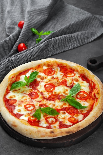 Fresh margarita pizza with tomatoes, basil, mozzarella cheese