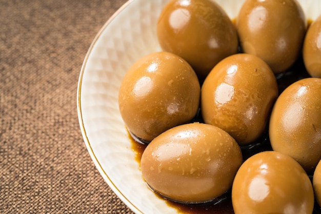 Fresh marinated eggs on a simple background