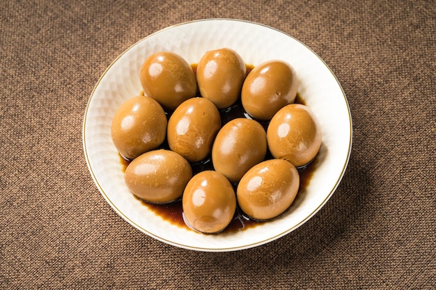 Fresh marinated eggs on a simple background