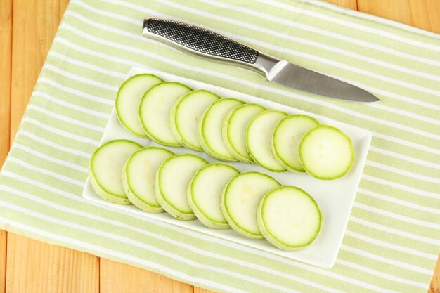 Photo fresh marrows on plate on wooden background