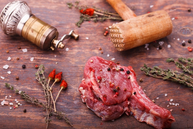  Fresh meat on the bone steak with spices and herbs