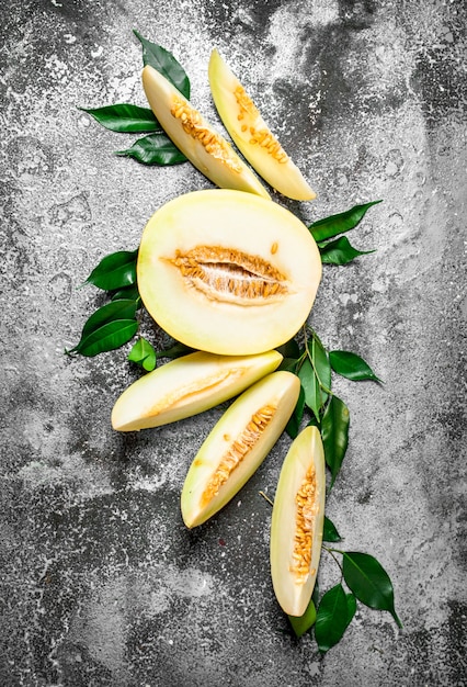 Fresh melon with green leaves.