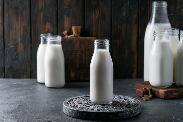 Fresh milk in different glass bottles