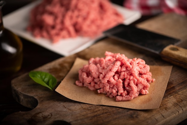 Fresh Minced Meat on vintage wooden background close up