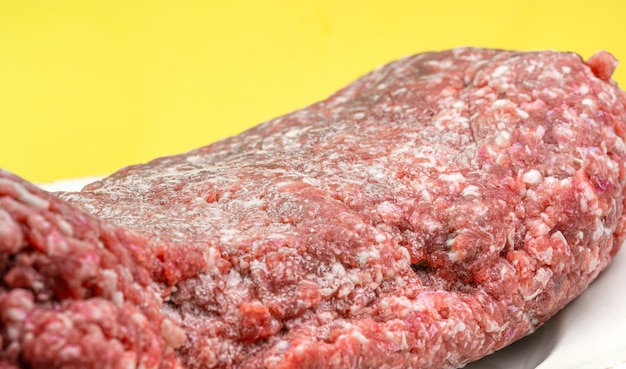 Carne macinata fresca su fondo giallo