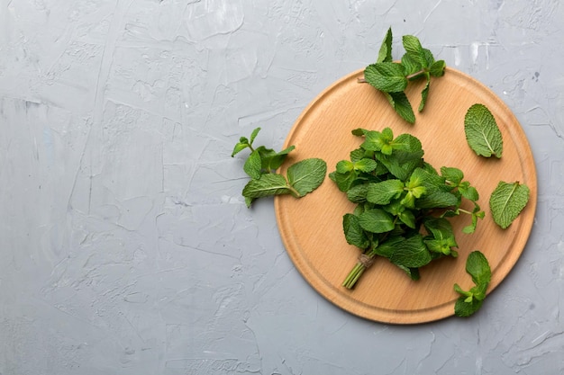 Fresh mint on Cutting board table top view Flat lay Space for text