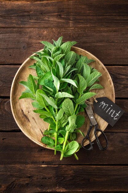 Fresh mint leaves on wooden rustic table top view