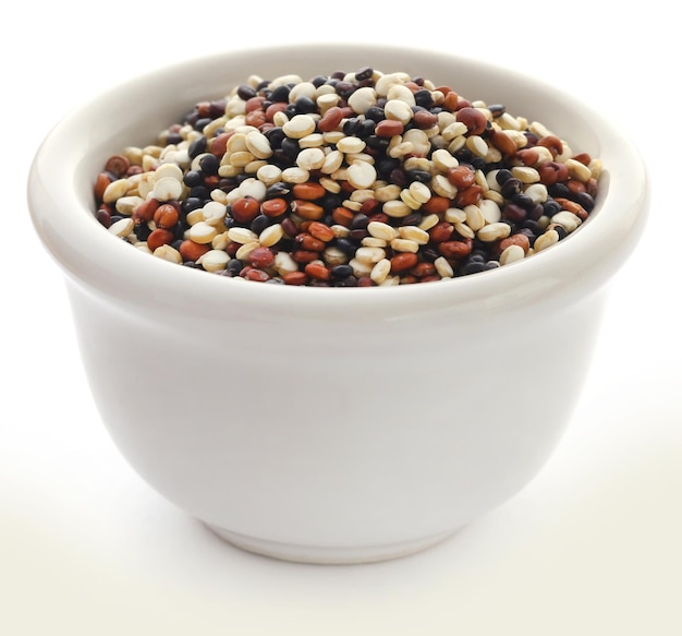 Fresh mixed quinoa in a bowl over white background