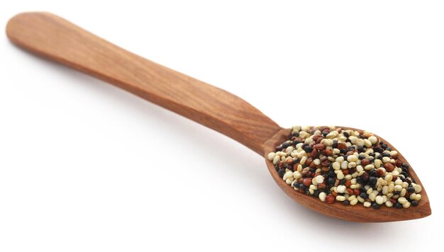 Fresh mixed quinoa in wooden spoon