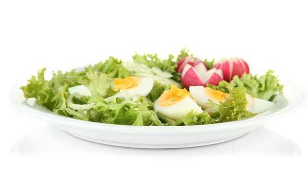 Fresh mixed salad with eggs salad leaves and other vegetables isolated on white