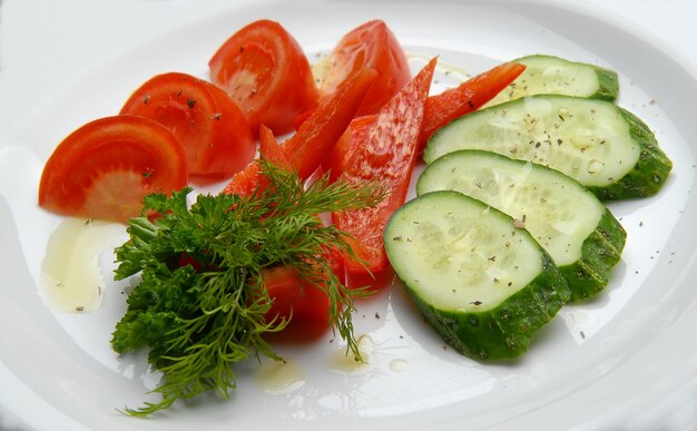 Fresh mixed vegetables on a plate poured oil