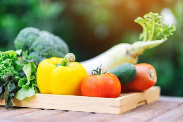 A fresh mixed vegetables in a wooden tray on the table