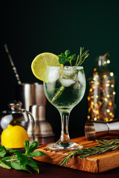 Fresh Mojito cocktail with lemon mint and ice in jar glass on dark blue background Summer cocktail