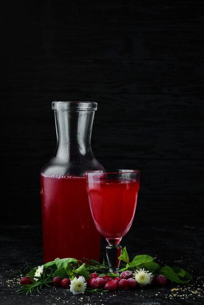 Fresh Morse of Cranberry Berries In a glass Top view On a black background