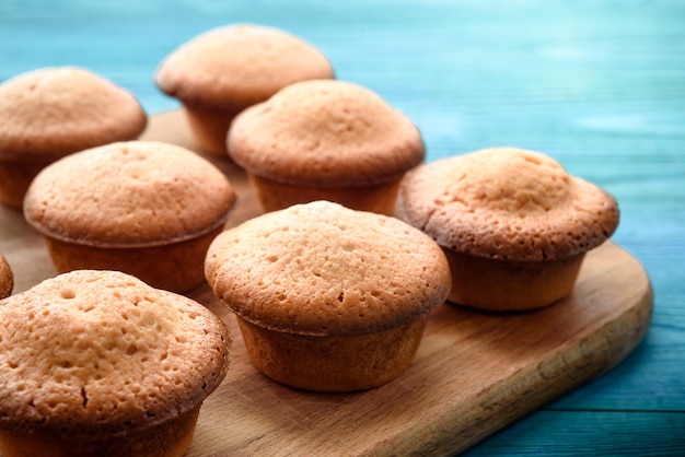 Fresh muffins on a blue wooden table Copy space Top Views