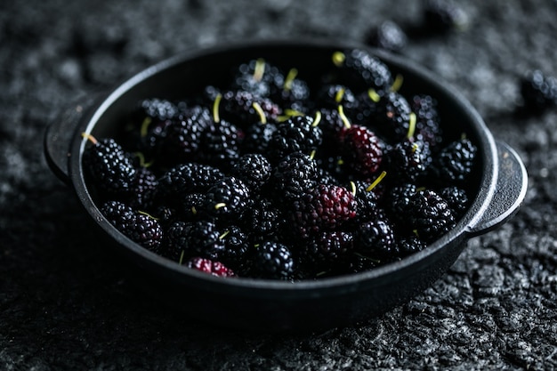 Fresh mulberries background. Various summer black fruits.