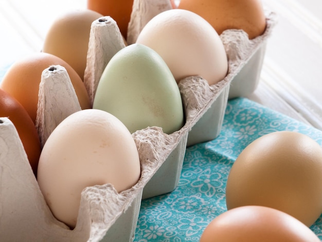 Fresh multi-color farm eggs on the table.