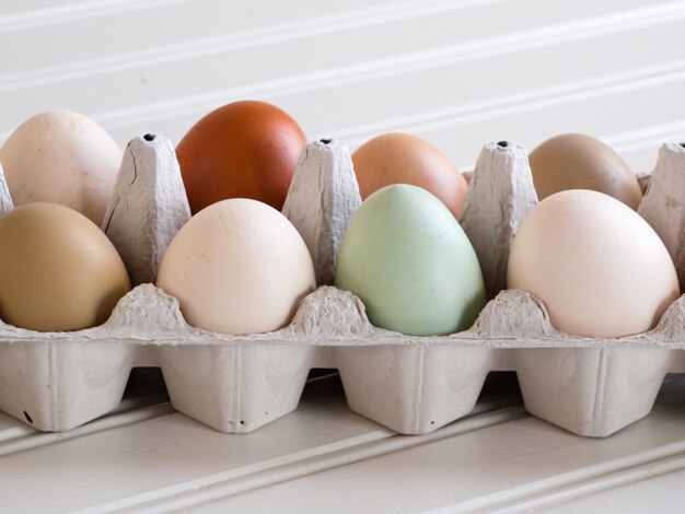 Fresh multi-color farm eggs on the table.