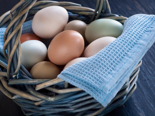 Fresh multi-color farm eggs on the table.