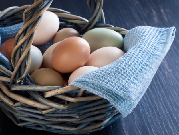 Fresh multi-color farm eggs on the table.