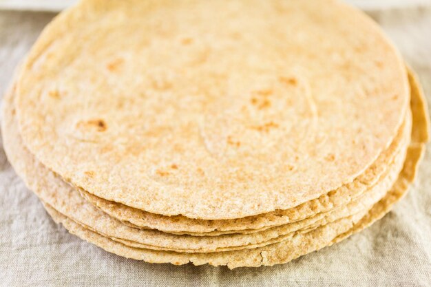 Fresh multi-grain tortillas on a linen dinner napkin.