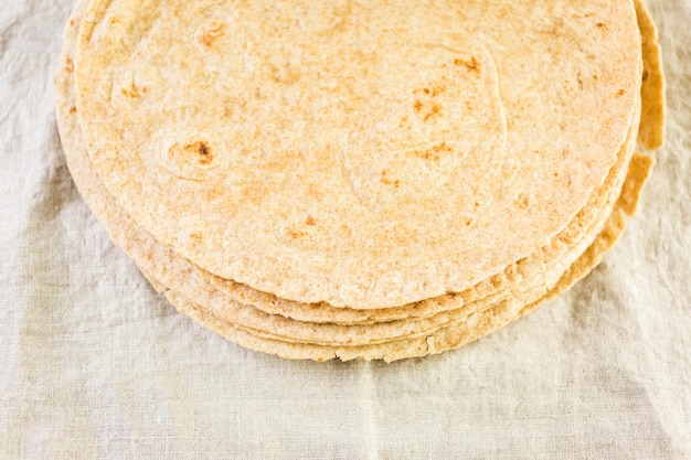 Fresh multi-grain tortillas on a linen dinner napkin.