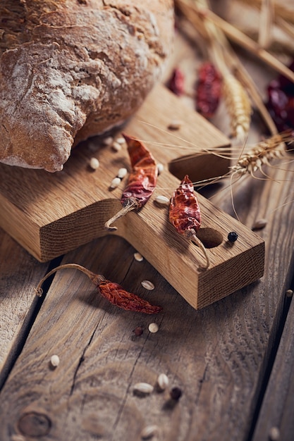 Fresh multigrain crusty bread, chilly pepper and wheat ears