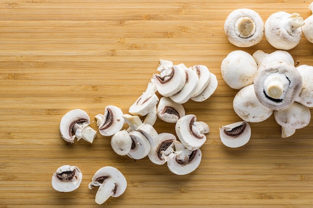 Fresh mushrooms champignon on a wooden board