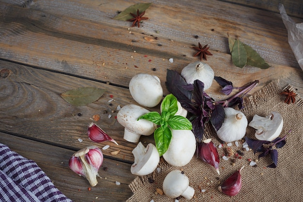 Fresh mushrooms and garlic on rustic wood