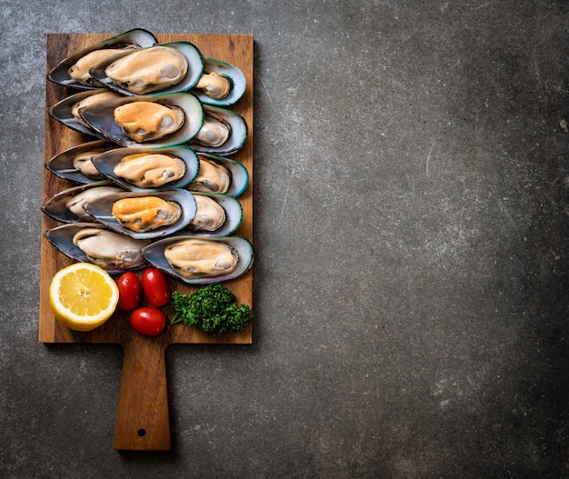 fresh mussel on wood board