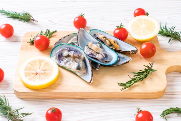 fresh mussels on wooden board