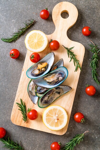 fresh mussels on wooden board