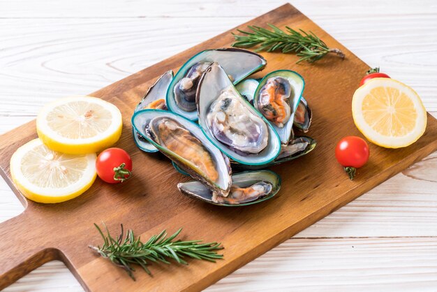 fresh mussels on wooden board